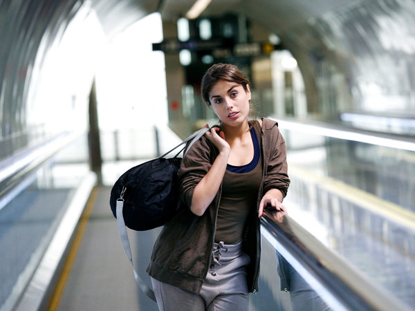 Woman with purse in moving walkway